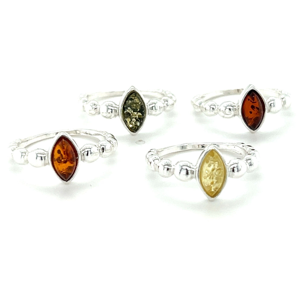 This description is about four Modern Amber Rings with Half Beaded Band, made of .925 Sterling Silver and embellished with amber and yellow stones by Super Silver.
