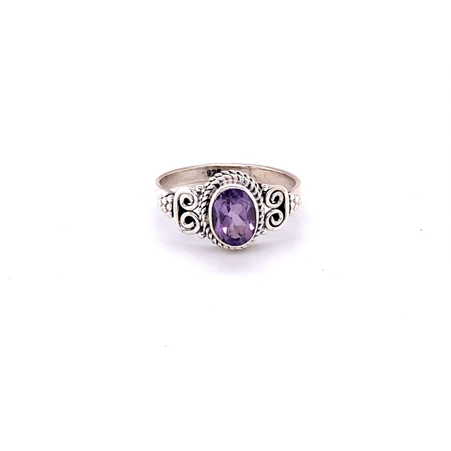 
                  
                    Oval Faceted Gemstone Ring with a Swirl Design: A silver ring with a cabochon amethyst stone.
                  
                