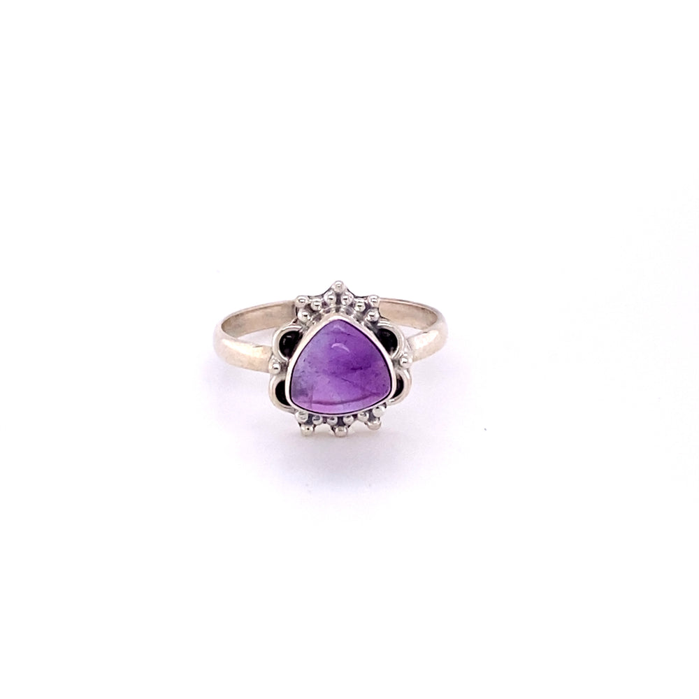 
                  
                    A boho-inspired Triangular Gemstone Ring with Frills with a cabochon design on a white background.
                  
                