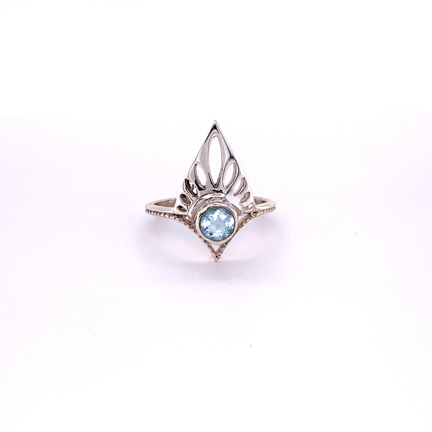 
                  
                    A Henna Shield Ring with Natural Gemstones featuring a blue topaz stone.
                  
                
