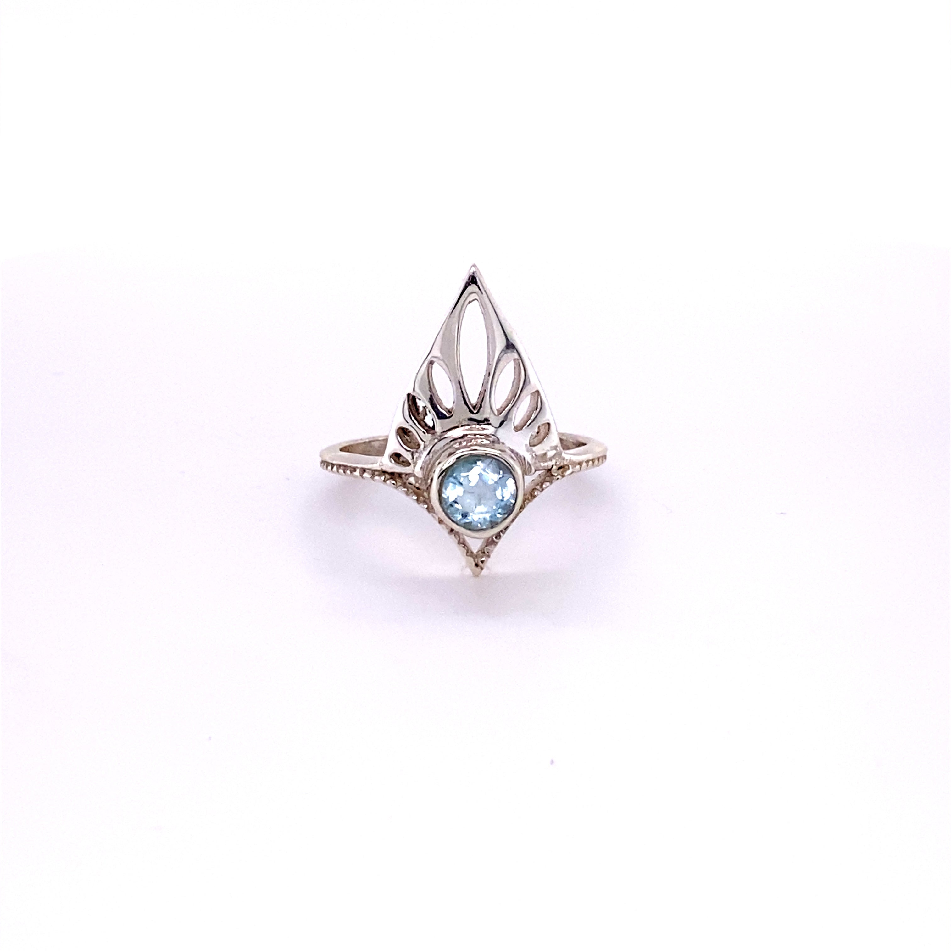 A Henna Shield Ring with Natural Gemstones featuring a blue topaz stone.