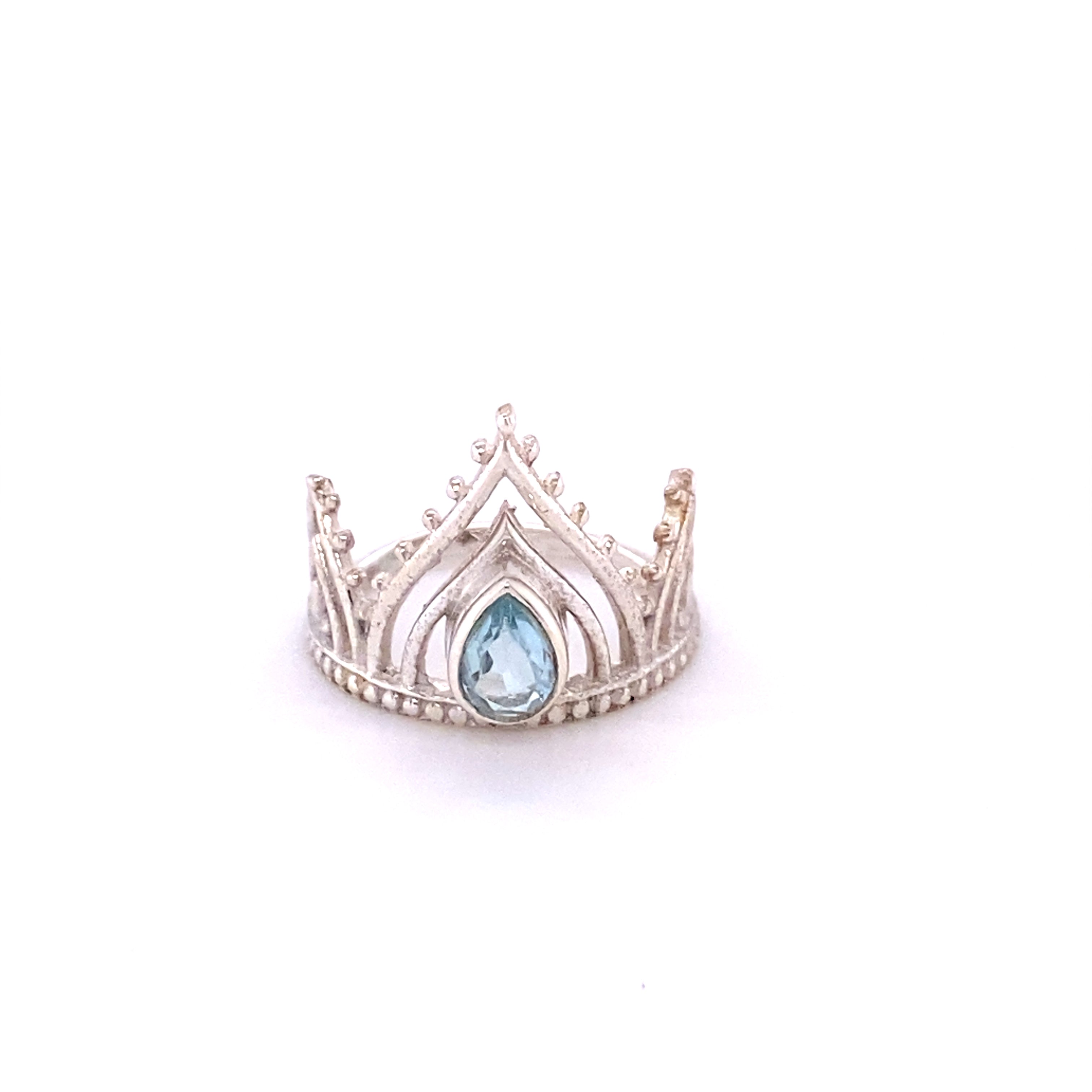 A Henna Crown Ring with Natural Gemstones with a blue topaz stone.