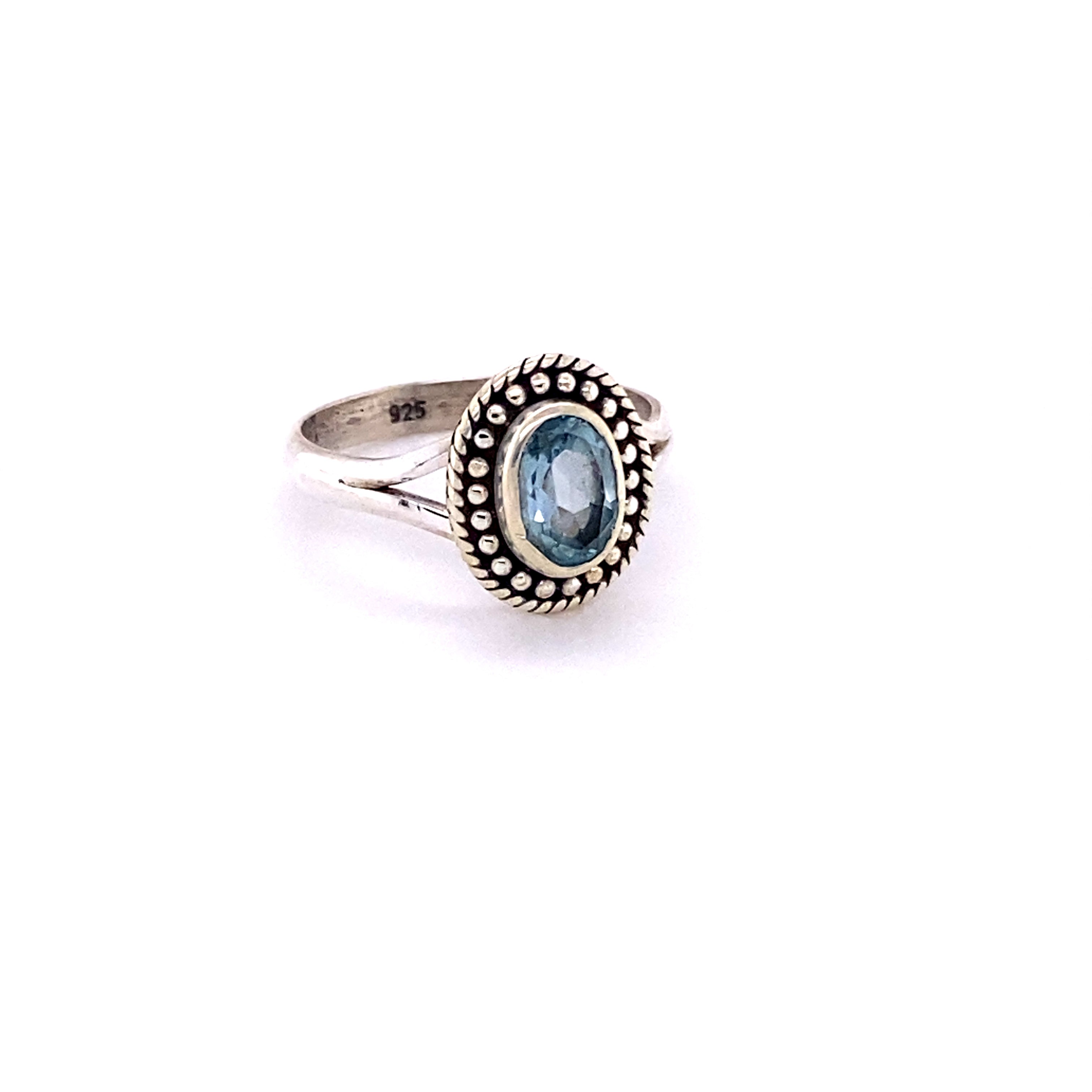 An Oval Gemstone Ring with Ball Disk Rope Border with a boho blue topaz stone.