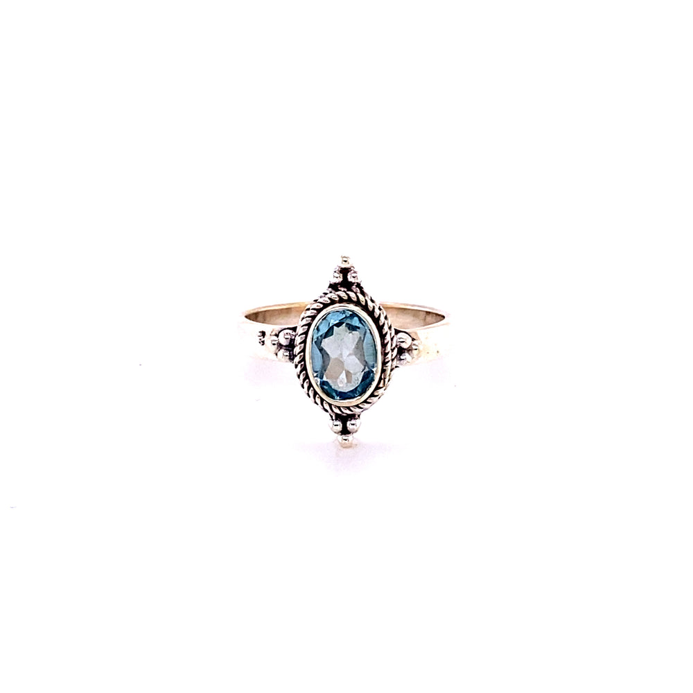 
                  
                    A Four Points Gemstone Ring with an oval blue topaz stone.
                  
                