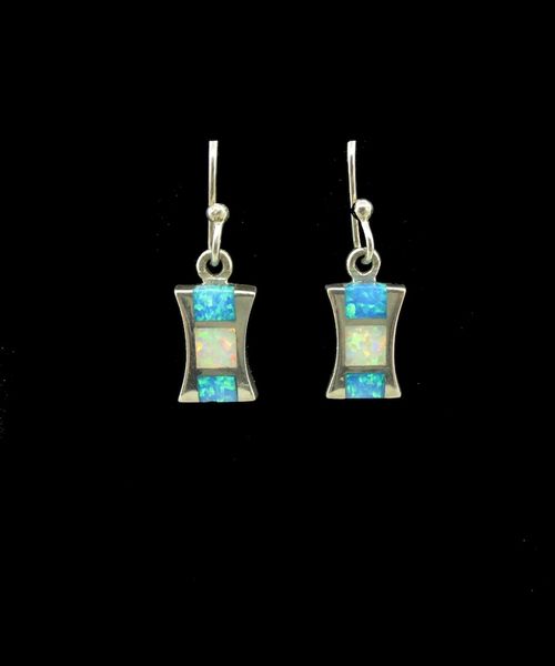 A pair of Super Silver Blue and White Created Opal Hourglass Earrings on a black background, showcasing their stunning color.