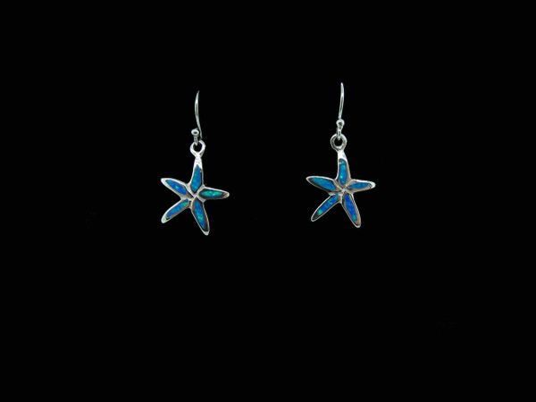 A pair of Super Silver Blue Created Opal Star Fish Earrings on a black background.