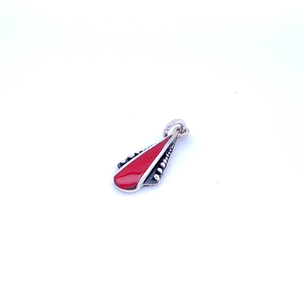 A Super Silver teardrop pendant with inlaid stones and a ball border, featuring a small red and black design on a white background.