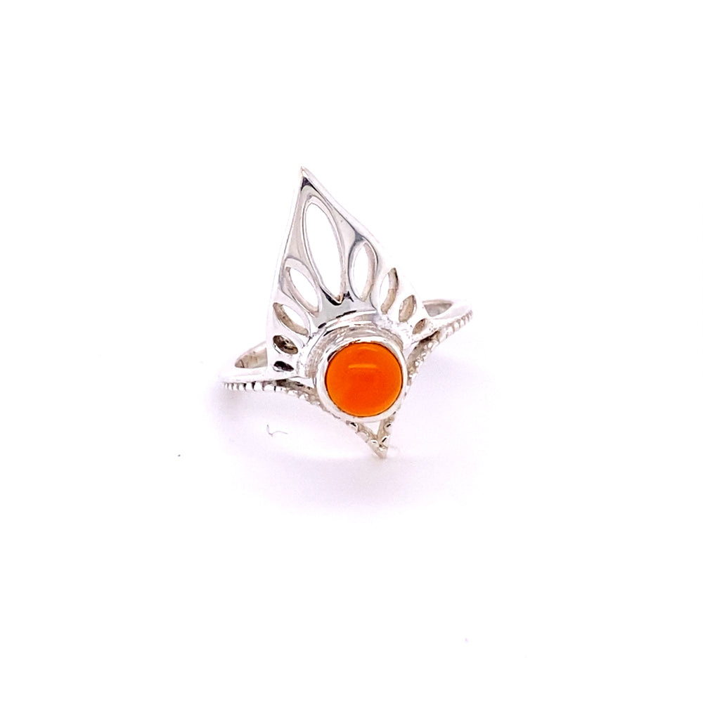 
                  
                    A Henna Shield Ring with Natural Gemstones with an orange cabochon stone.
                  
                