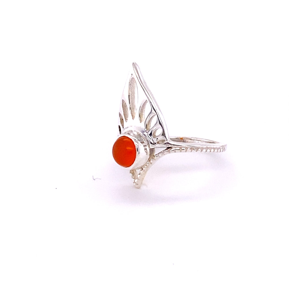 
                  
                    A Henna Shield Ring with Natural Gemstones with an orange stone.
                  
                