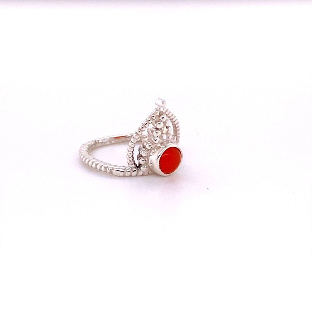 
                  
                    A Simple Tiara Ring with Natural Gemstones, with an orange cabochon stone.
                  
                
