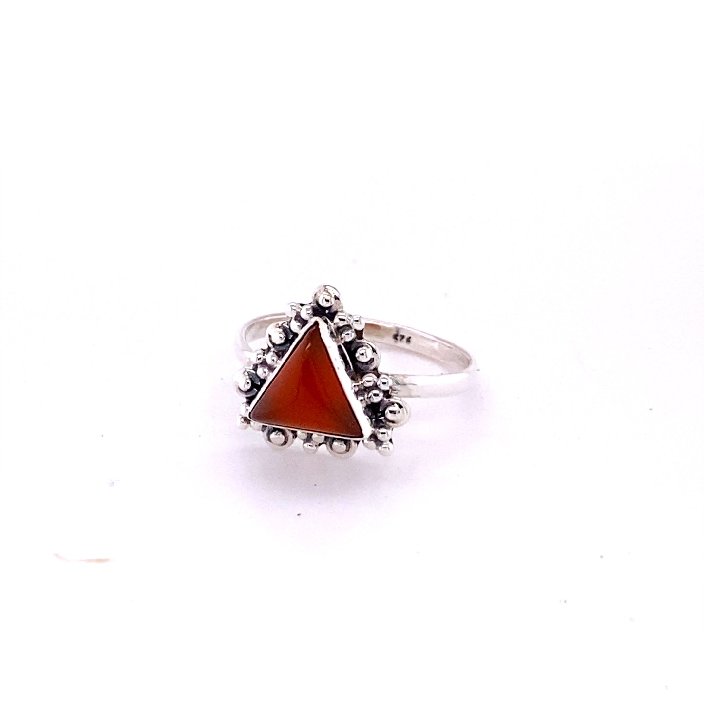 
                  
                    A Delicate Gemstone Triangle Ring with a silver band and an orange stone in the middle from Super Silver.
                  
                