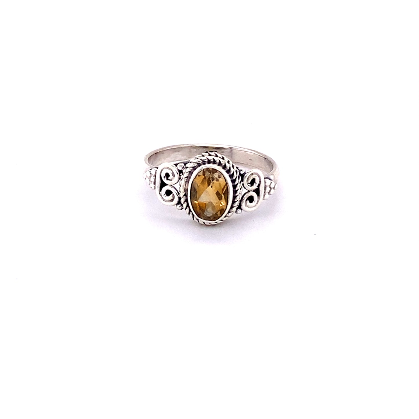 
                  
                    An oval faceted gemstone ring with a swirl design.
                  
                