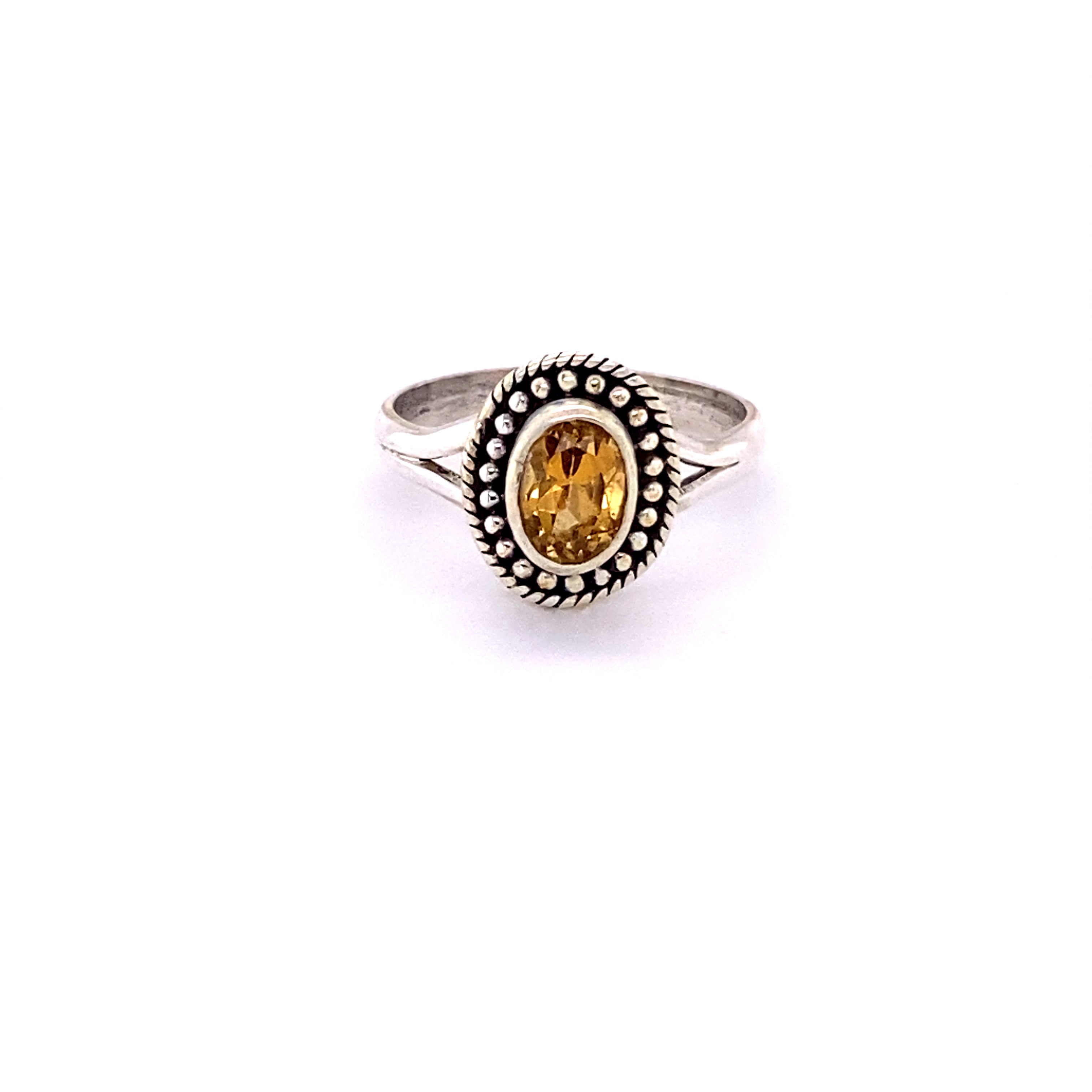 A boho oval gemstone ring with a ball disk rope border.
