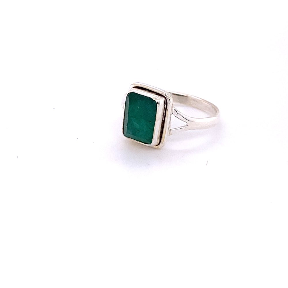 
                  
                    A simple square gemstone ring on a white background.
                  
                