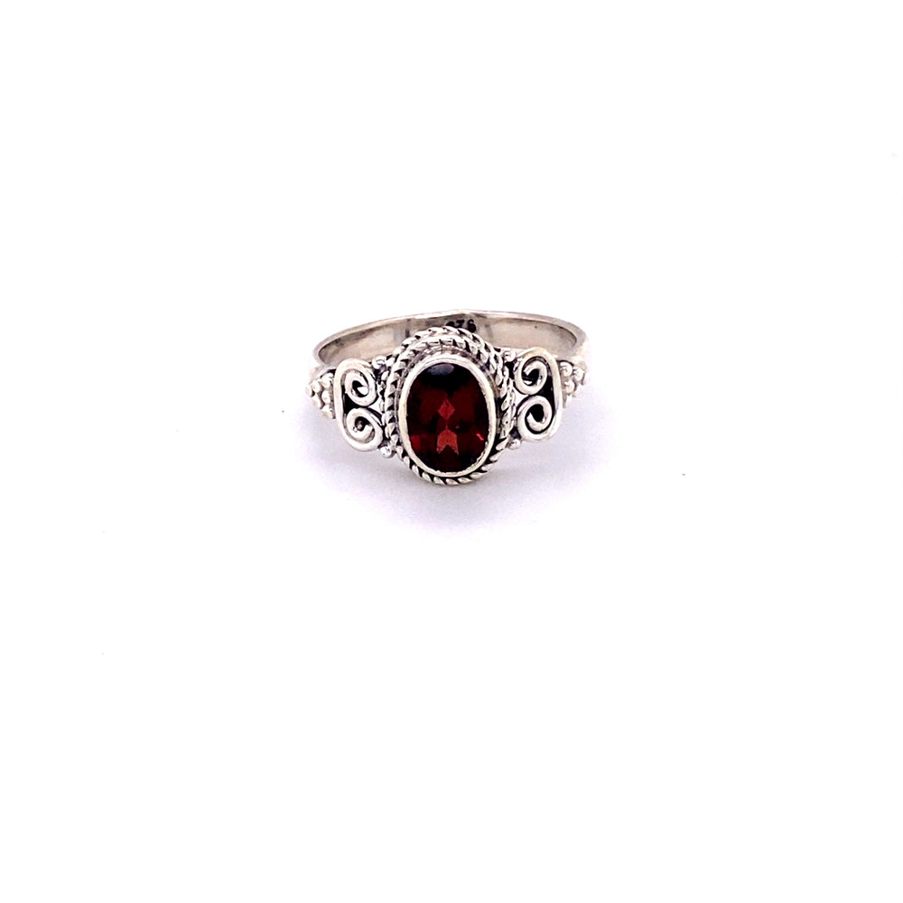 
                  
                    A sterling silver oval faceted gemstone ring with a swirl design.
                  
                