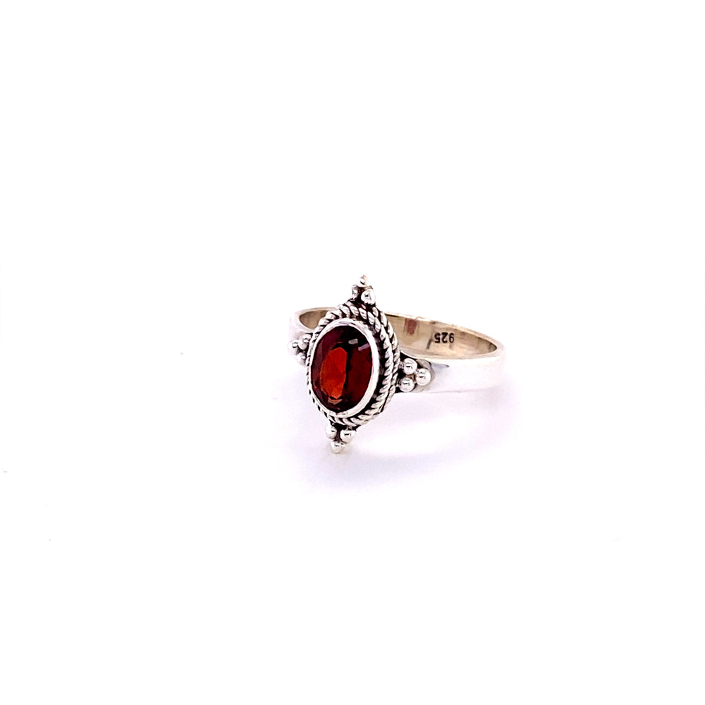
                  
                    A sterling silver Four Points Gemstone Ring with a stunning red garnet stone.
                  
                