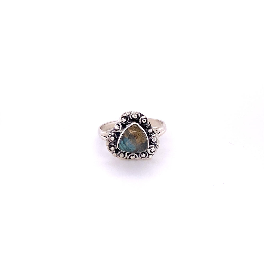 
                  
                    A boho-inspired Triangular Gemstone Ring with A Flat Ball Boarder featuring a mesmerizing labradorite cabochon.
                  
                