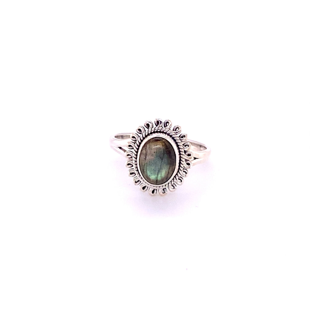 
                  
                    A silver Hippie-Chic Oval Gemstone Flower Ring with a labradorite cabochon stone.
                  
                