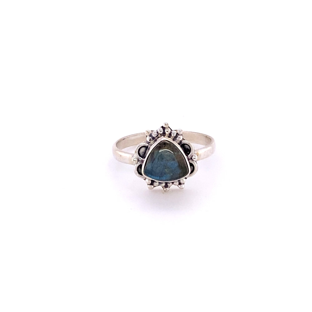 
                  
                    A Triangular Gemstone Ring with Frills from Super Silver with a blue gemstone in the middle.
                  
                