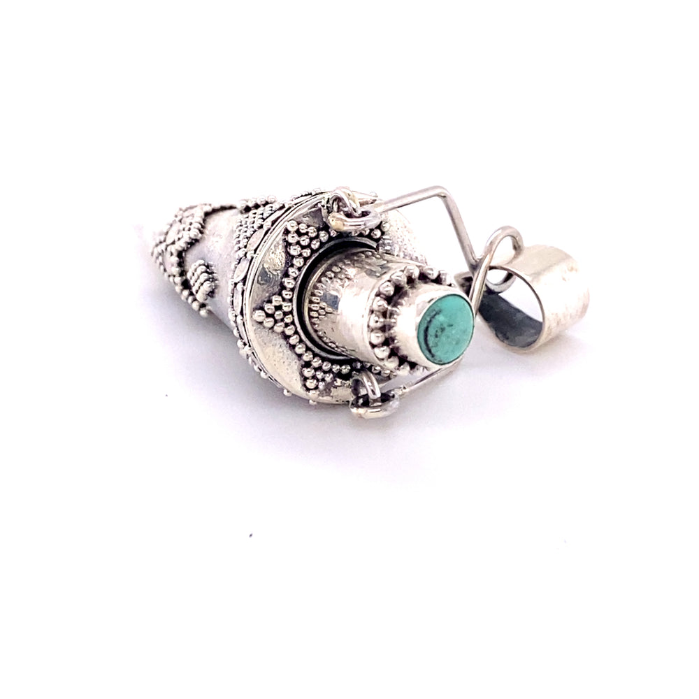 
                  
                    An Ornate Stone Poison Pendant with a turquoise gemstone, made by Super Silver.
                  
                