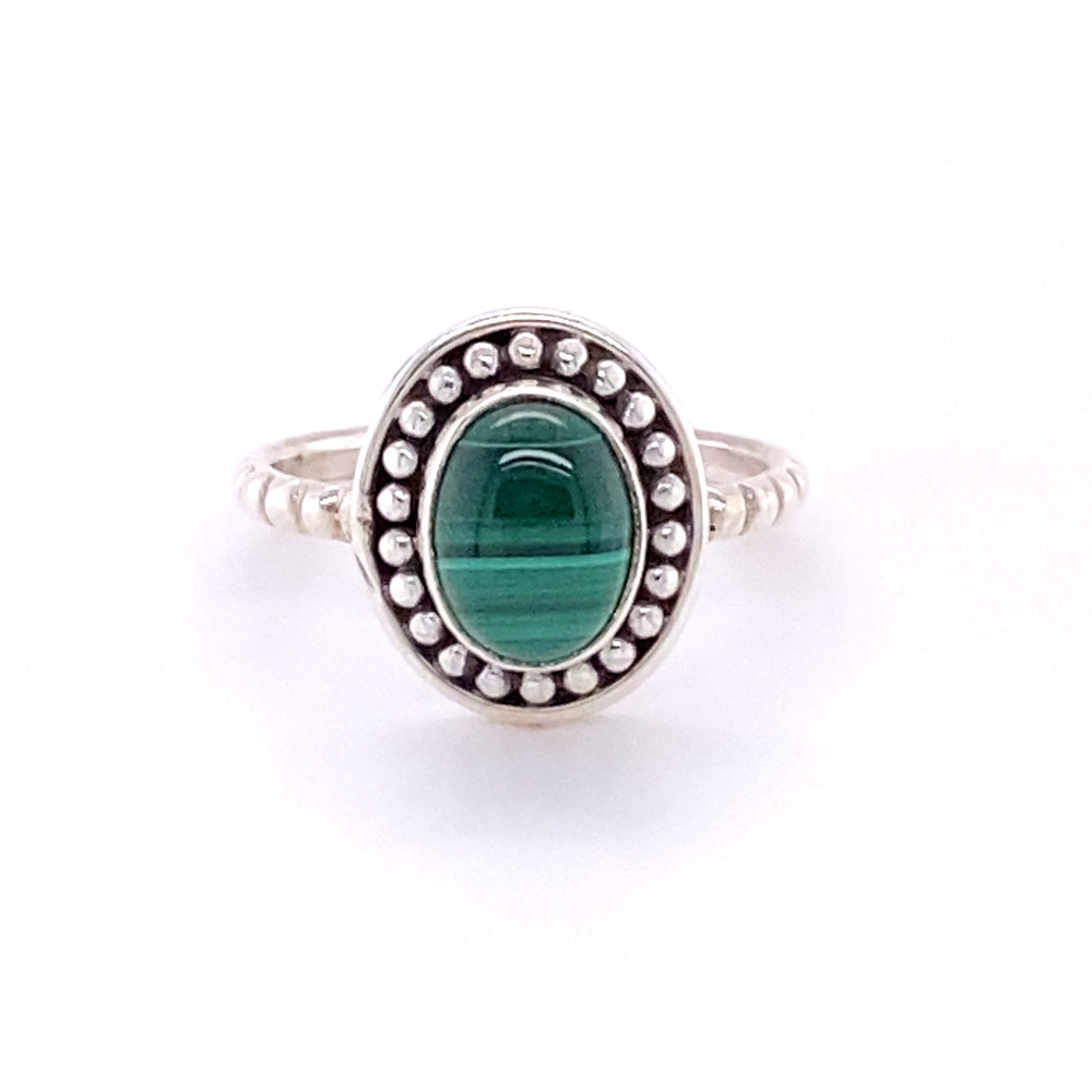 
                  
                    An oval gemstone ring with a silver ball border.
                  
                