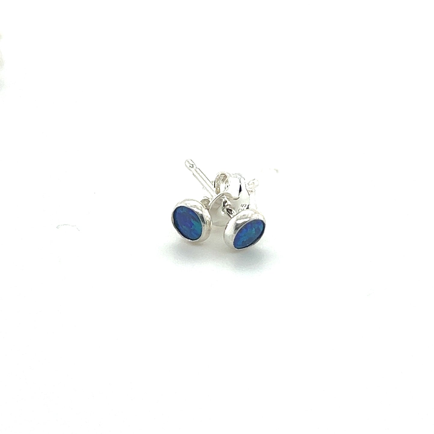 
                  
                    A pair of Super Silver Dainty Opal Studs with minimalist designs on a white surface.
                  
                