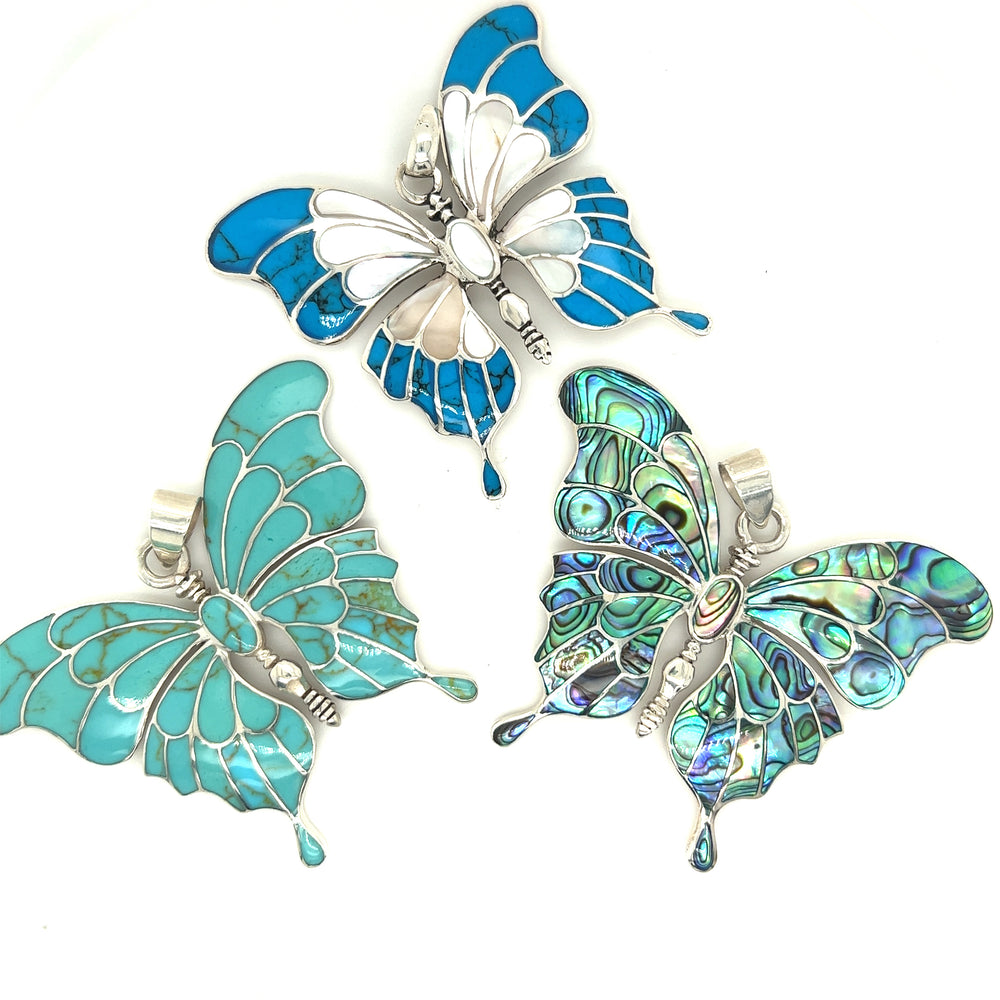 
                  
                    Three Stunning Inlay Butterfly Pendants by Super Silver on a white background.
                  
                