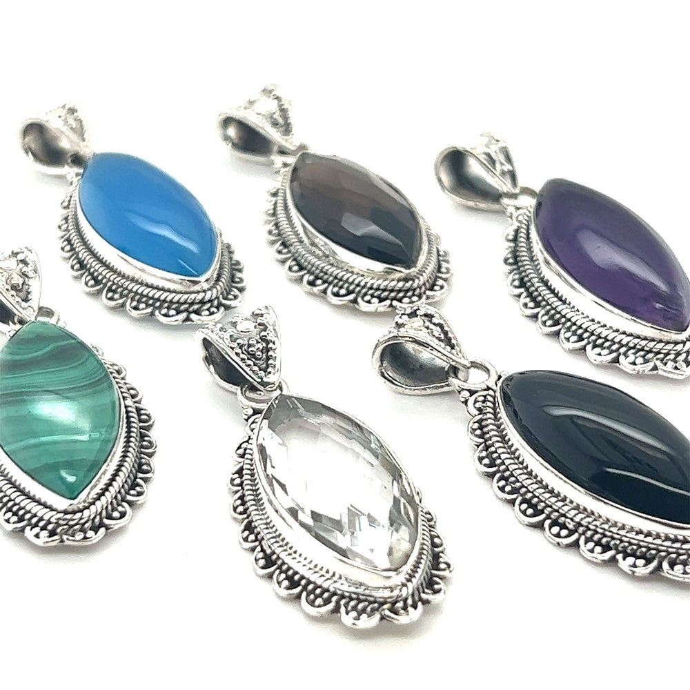 Four Marquise Shaped Gemstone Pendants on a white background.