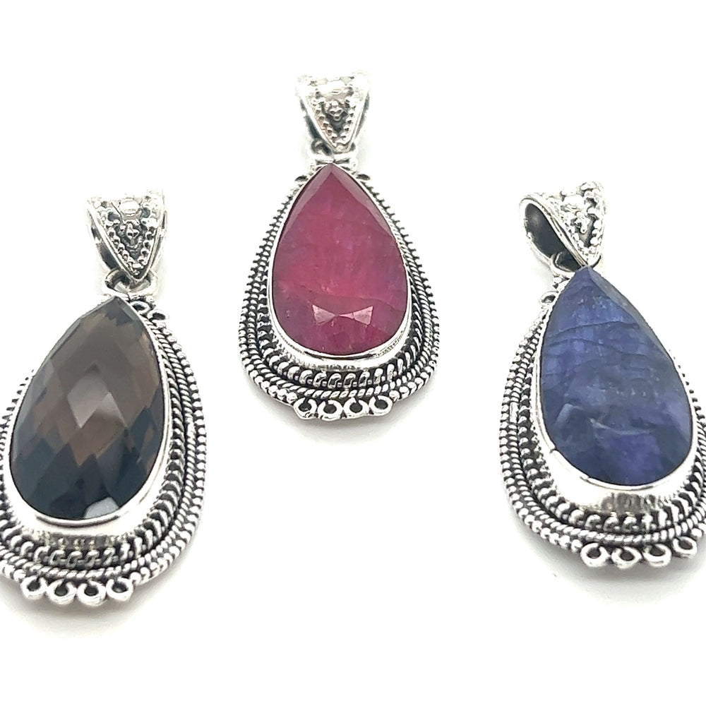 Three Super Silver Striking Teardrop Gemstone Pendants with Beaded Detailing on a white background.