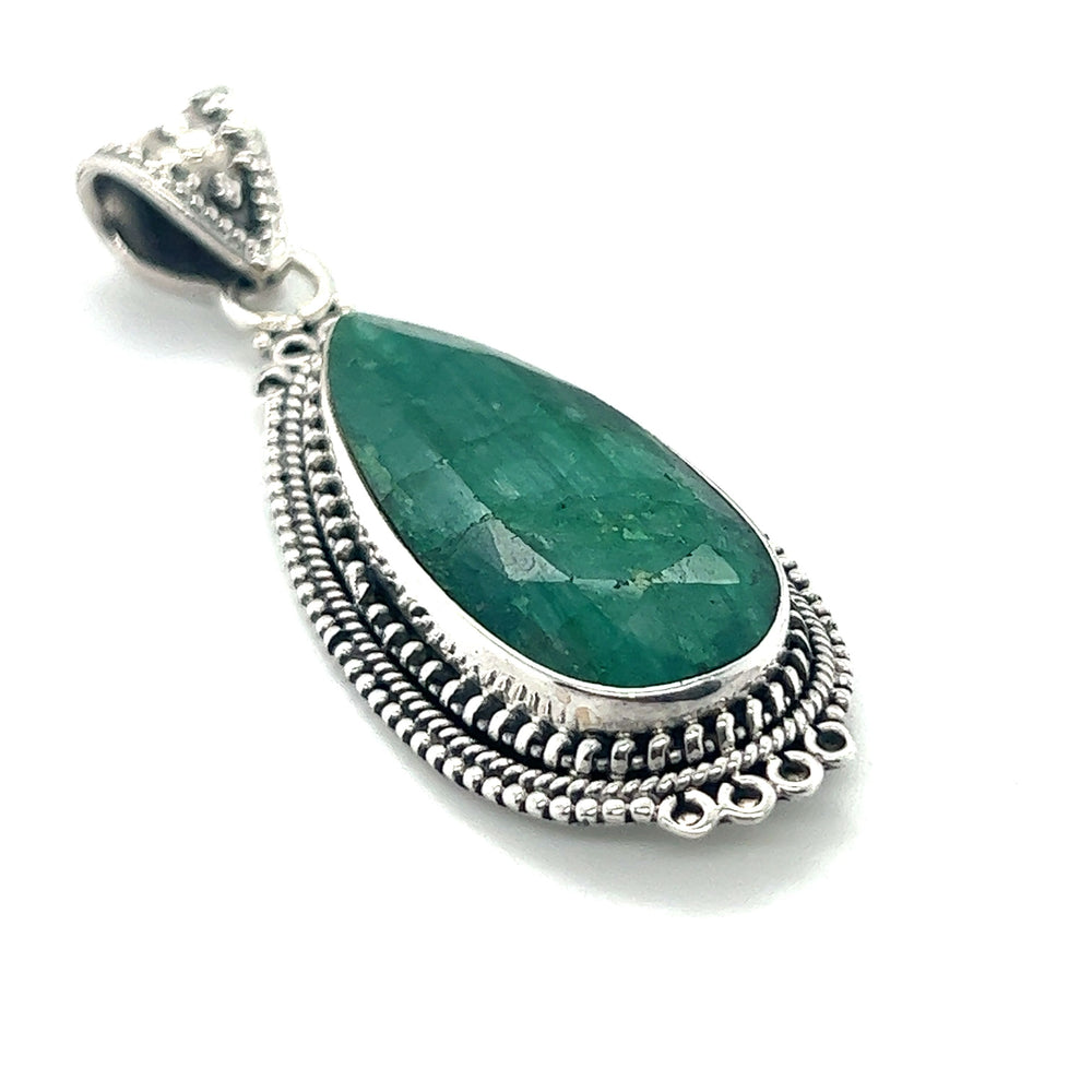 
                  
                    A Super Silver Striking Teardrop Gemstone Pendant with Beaded Detailing featuring an emerald stone.
                  
                