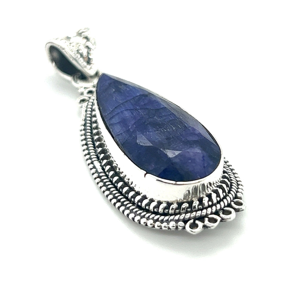 
                  
                    A Striking Teardrop Gemstone Pendant with Beaded Detailing by Super Silver, featuring a blue sapphire stone.
                  
                