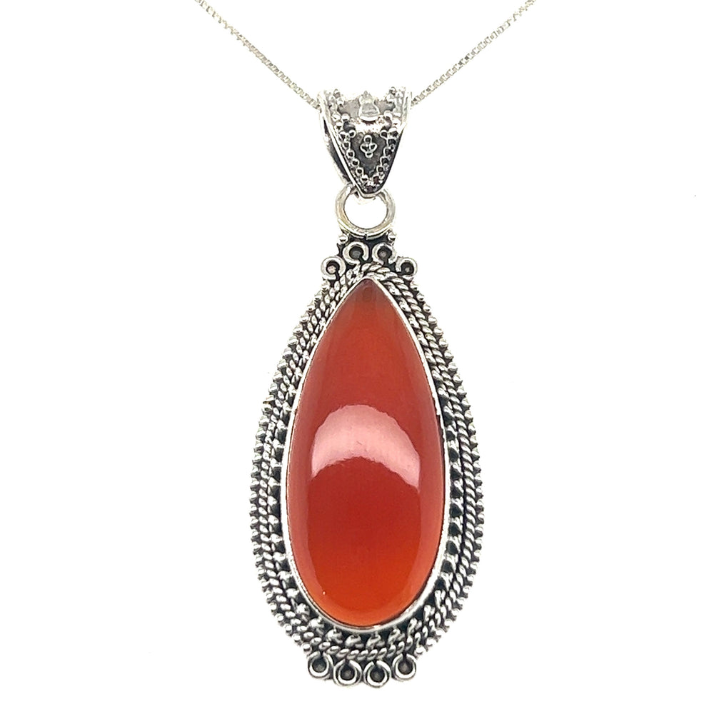 
                  
                    A Striking Teardrop Gemstone Pendant with Beaded Detailing on a Super Silver chain, inspired by Bali-style jewelry.
                  
                