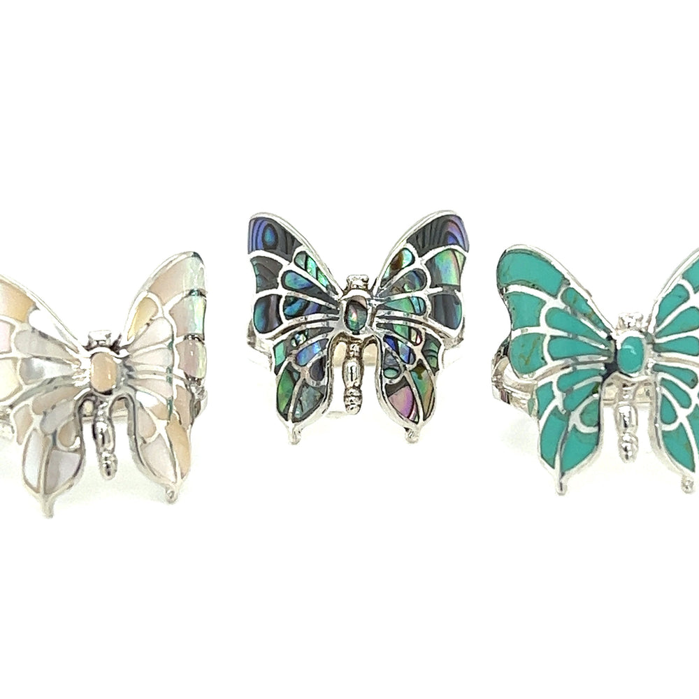 Three Intricate Statement Butterfly Inlay Rings with turquoise and mother of pearl stone accents.