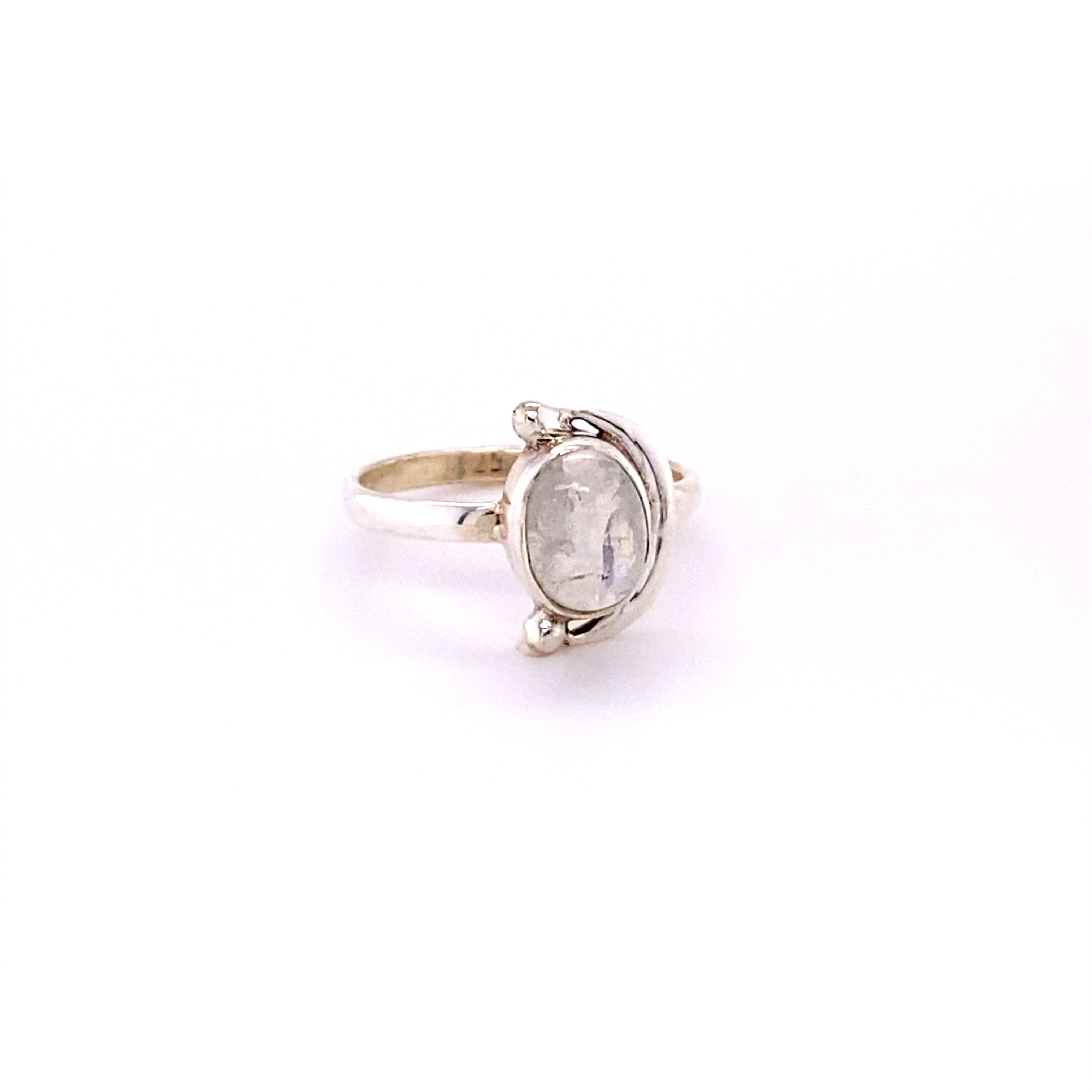 A Oval Crescent Moon Ring with Natural Gemstones with a white stone.