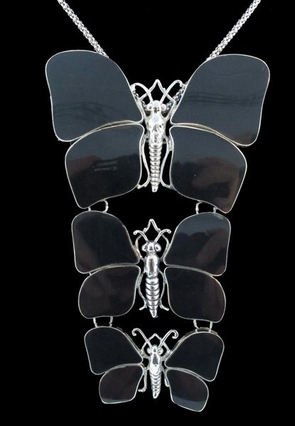 
                  
                    A Super Silver statement pendant adorned with three black butterfly pendants, perfect for the nature lover.
                  
                