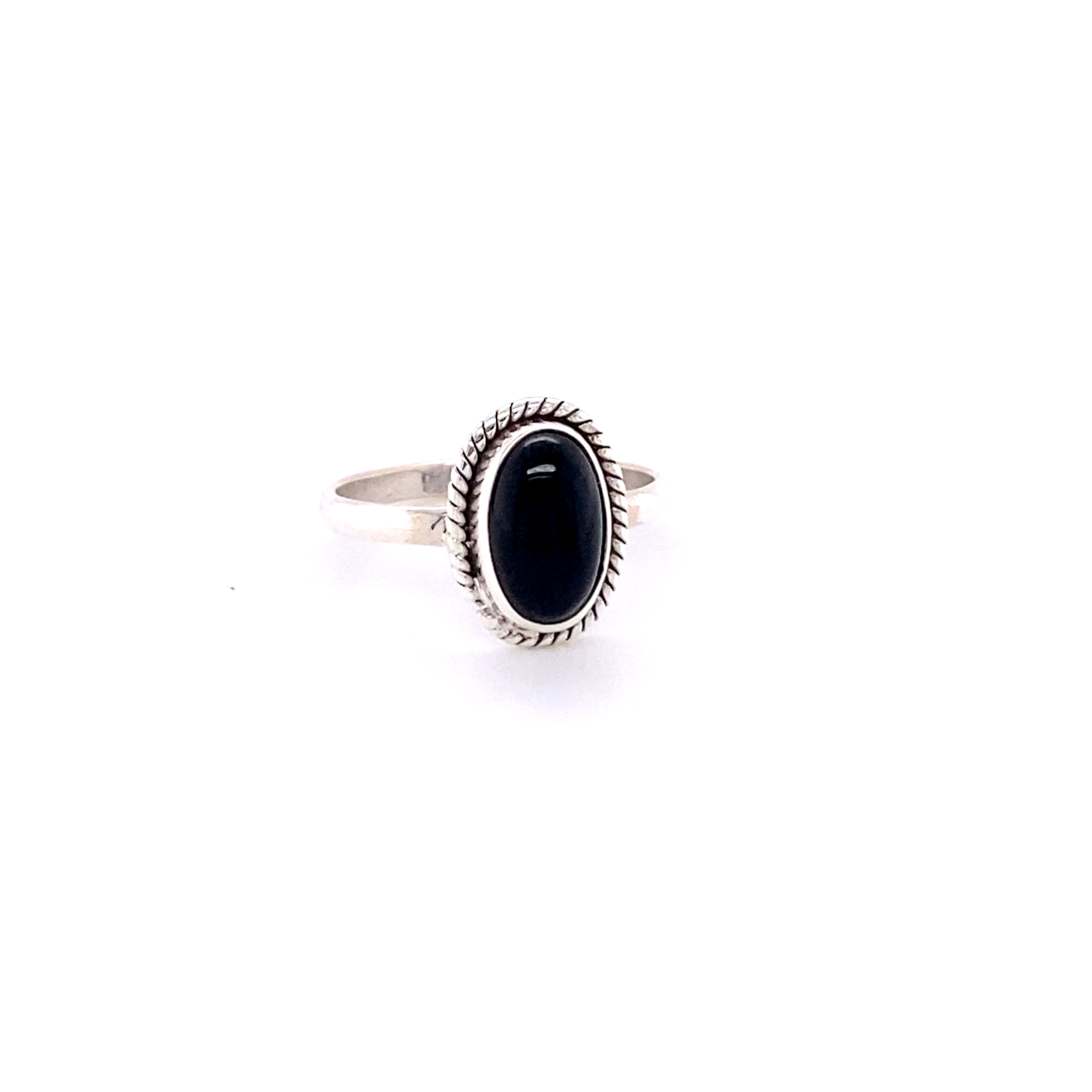 Simple oval gemstone ring with twisted rope border with an oval black stone set in a decorative bezel, displayed against a white background.