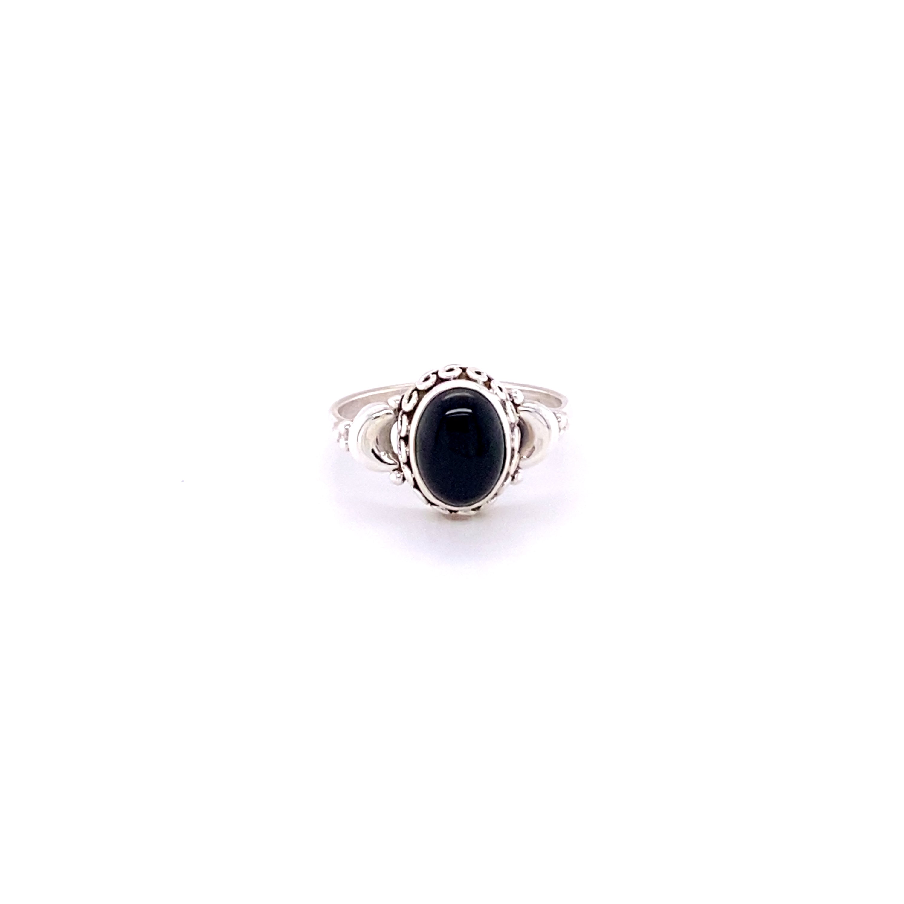 An oval black stone ring on a white background, reminiscent of the earthy and enchanting crescent moon. A Super Silver Beautiful Oval Gemstone Ring with Small Moons that exudes mystique and elegance.