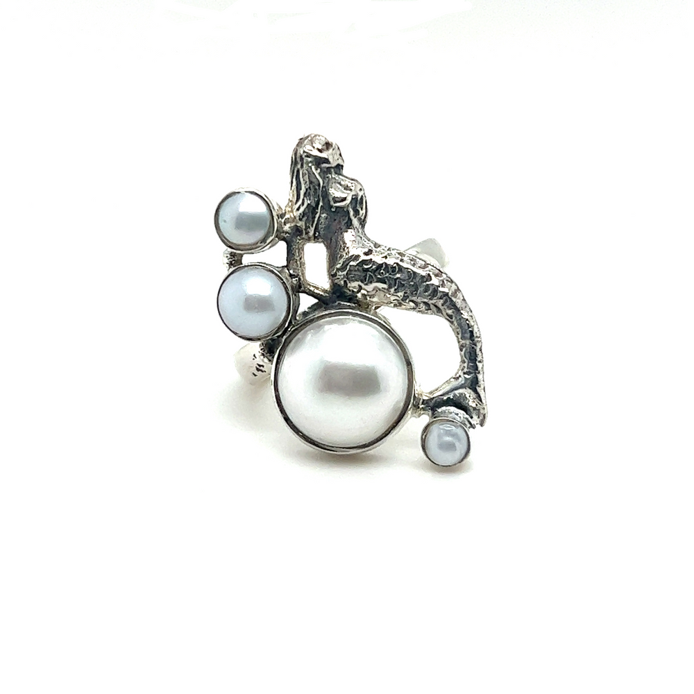 A sterling silver Mermaid Ring with Pearl adorned with a mesmerizing depiction of a mermaid.