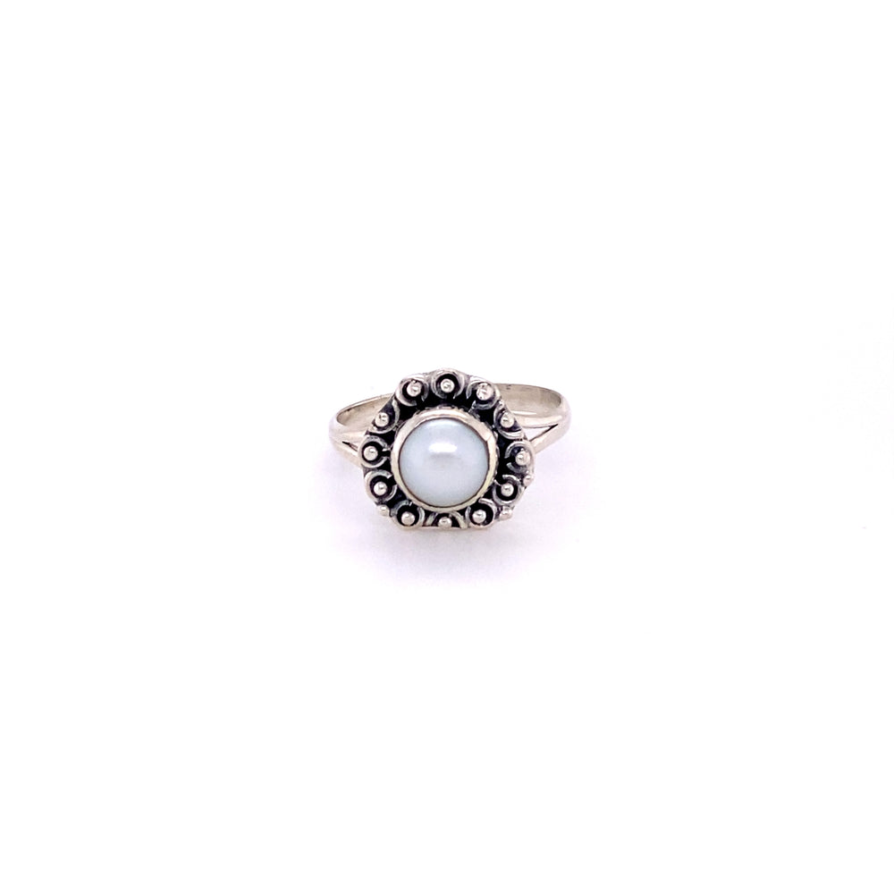 
                  
                    A triangular gemstone ring with a flat ball border and a blue cabochon stone in the center.
                  
                