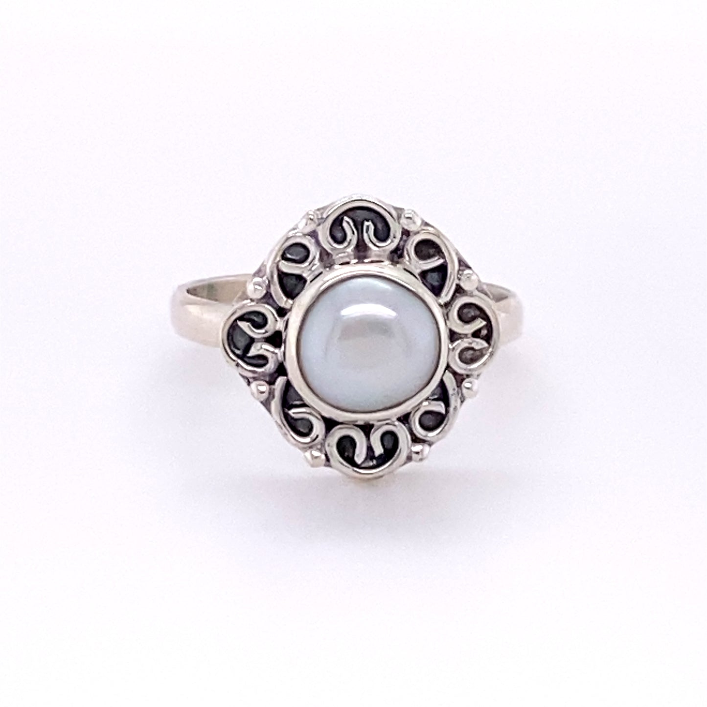 
                  
                    A boho-inspired Oval Gemstone Ring with Swirl Filigree Border in sterling silver with a pearl in the center.
                  
                