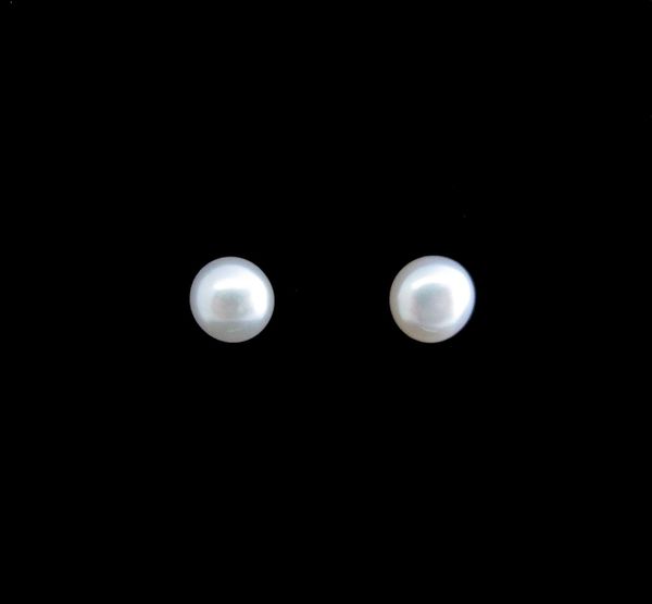 A pair of Super Silver Synthetic Pearl Small Round Studs on a black background.