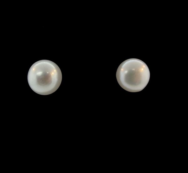 A pair of Super Silver Synthetic Pearl Round Studs on a black background.