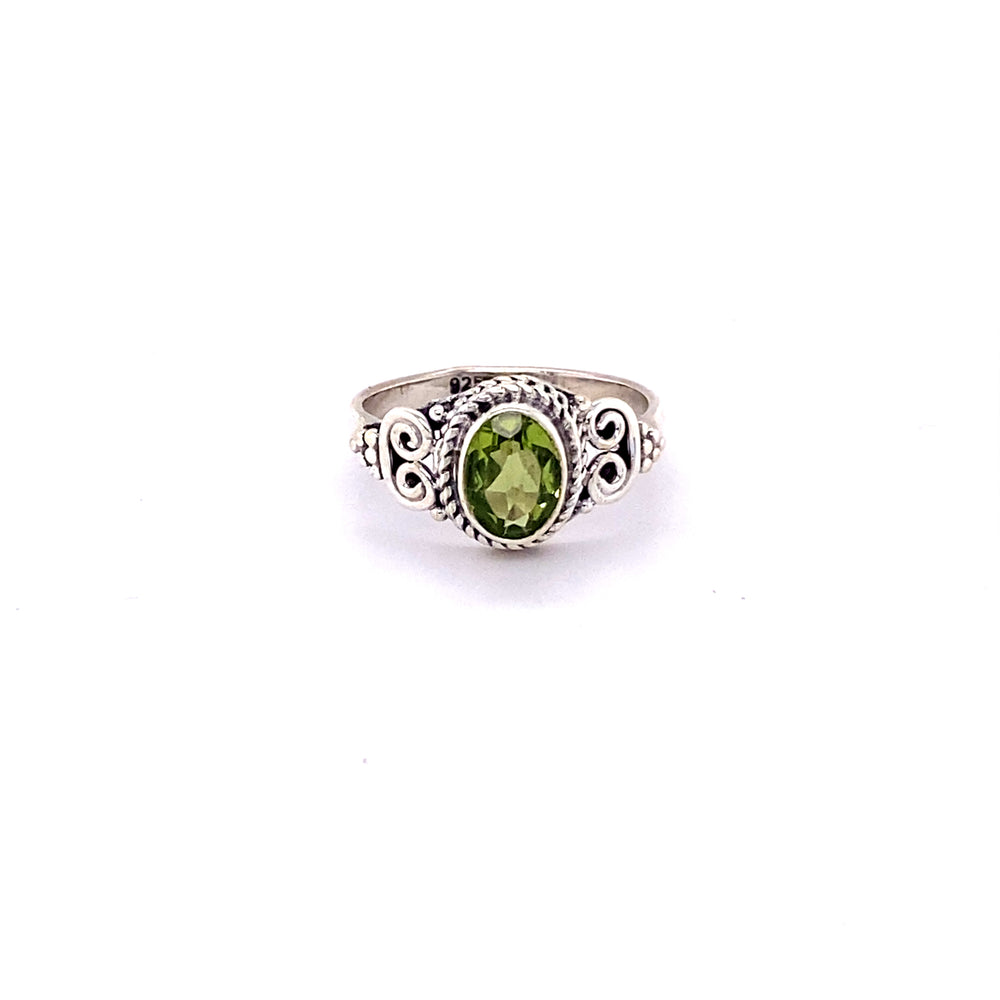 A boho-inspired Oval Faceted Gemstone Ring with a Swirl Design.
