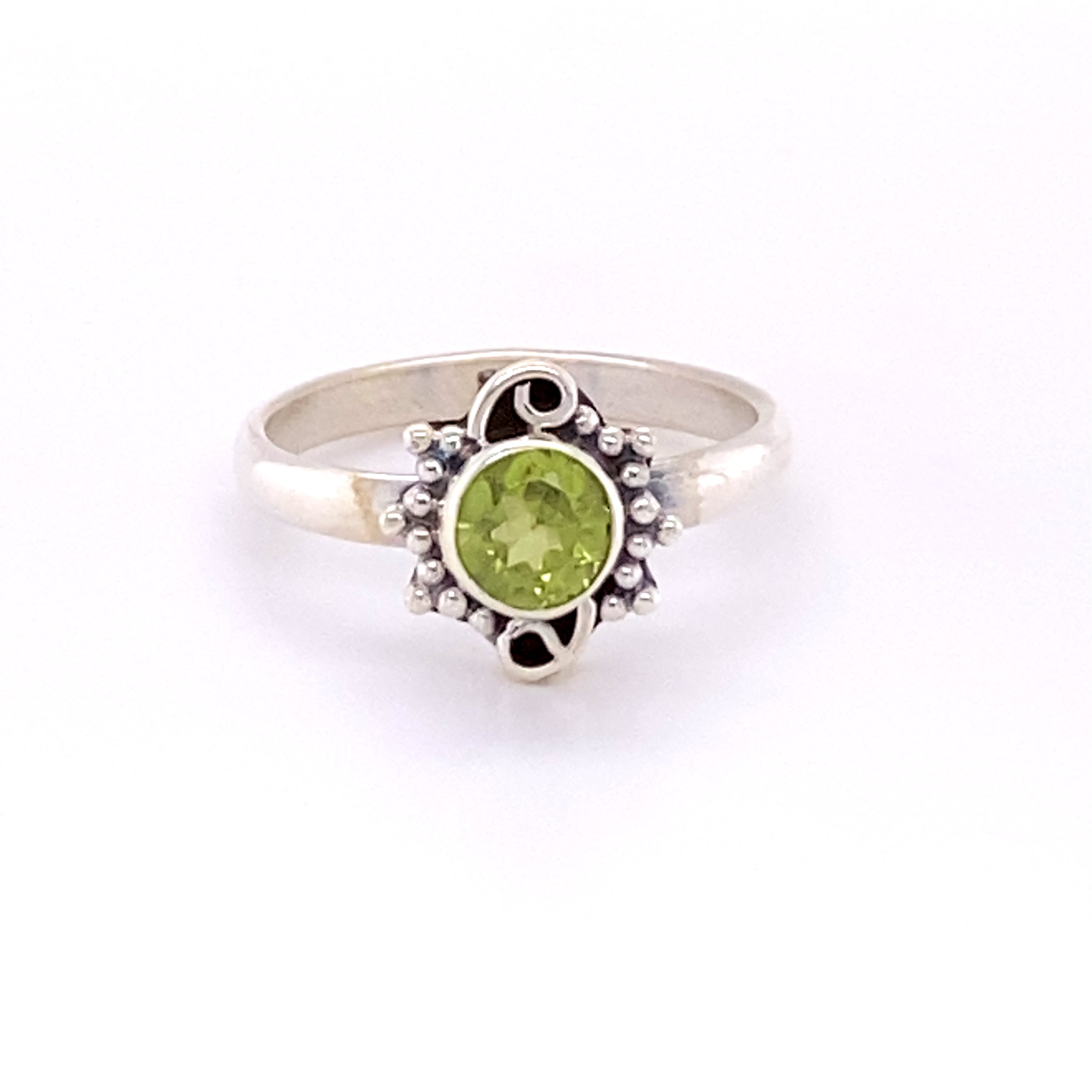 A Small Round Gemstone Ring with Bead and Swirl Border, perfect for boho fashion.