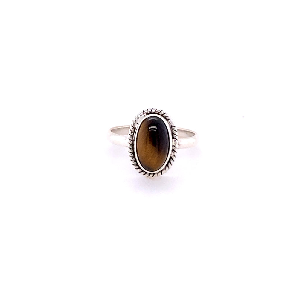 
                  
                    Simple Oval Gemstone Ring with Twisted Rope Border featuring a Tiger's Eye Gemstone set in a detailed, serrated bezel on a plain band, isolated on a white background.
                  
                