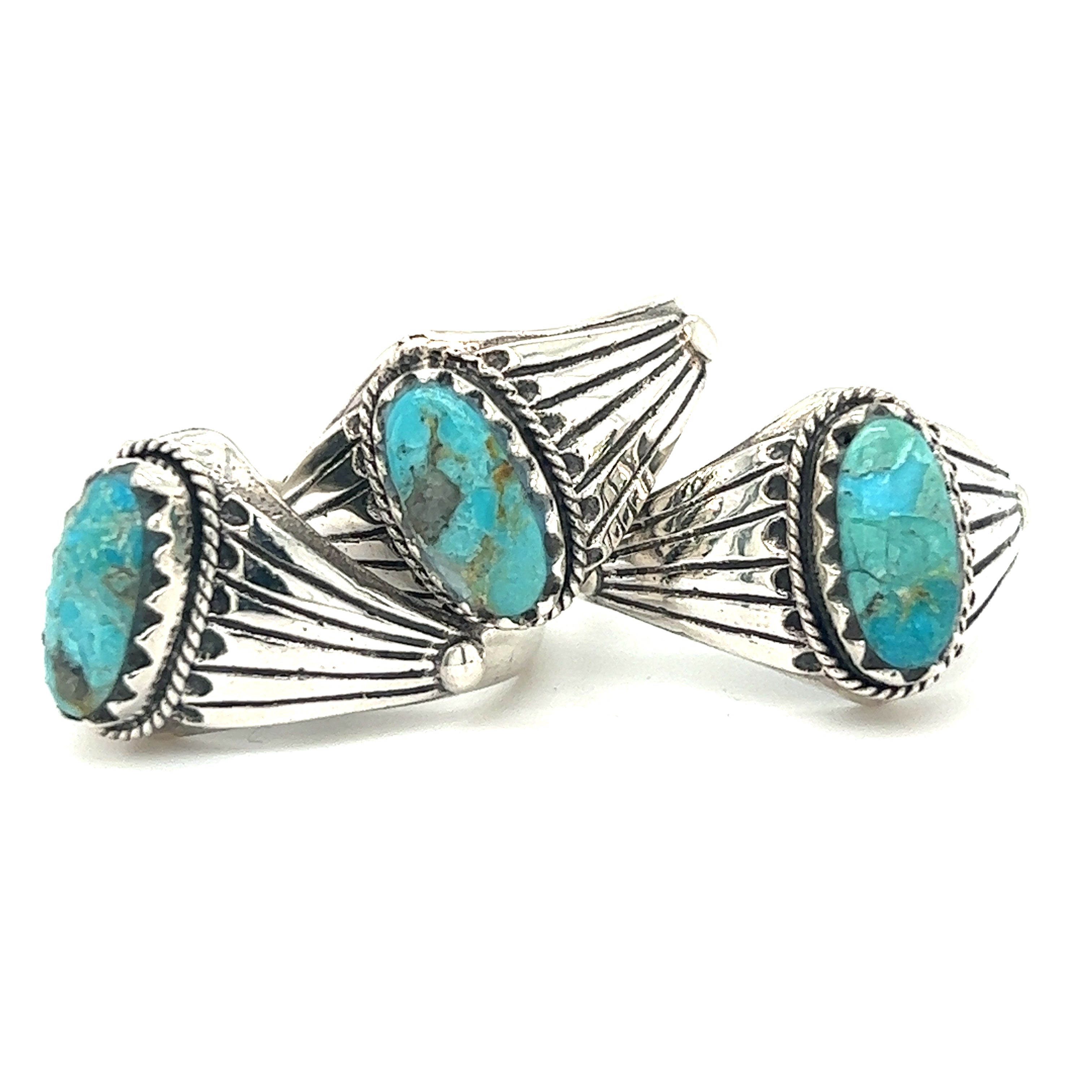 A pair of sterling silver signet rings with Southwest Inspired Kingman Turquoise Stones.