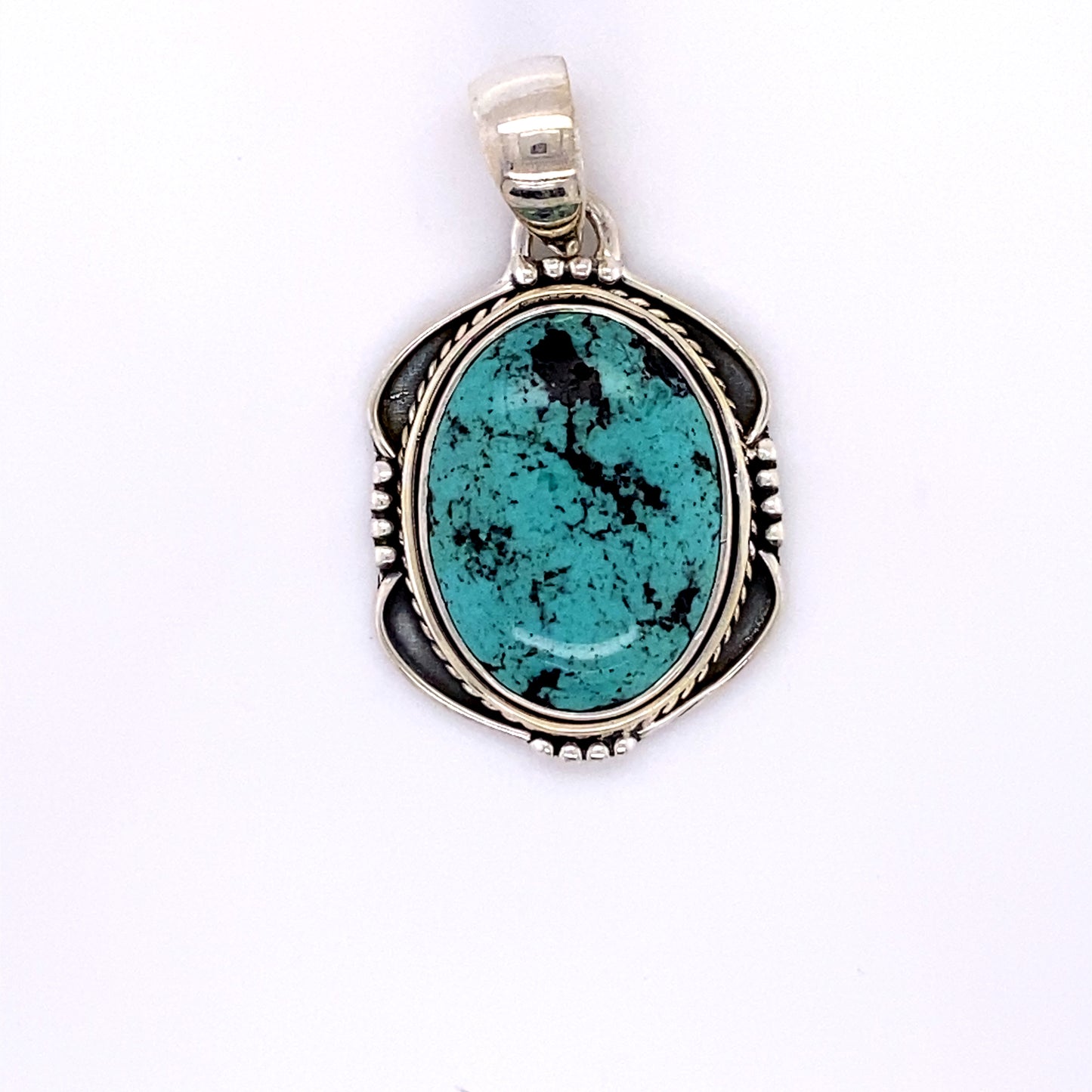 
                  
                    A Natural Turquoise Pendant with an Oval Shield Setting by Super Silver.
                  
                