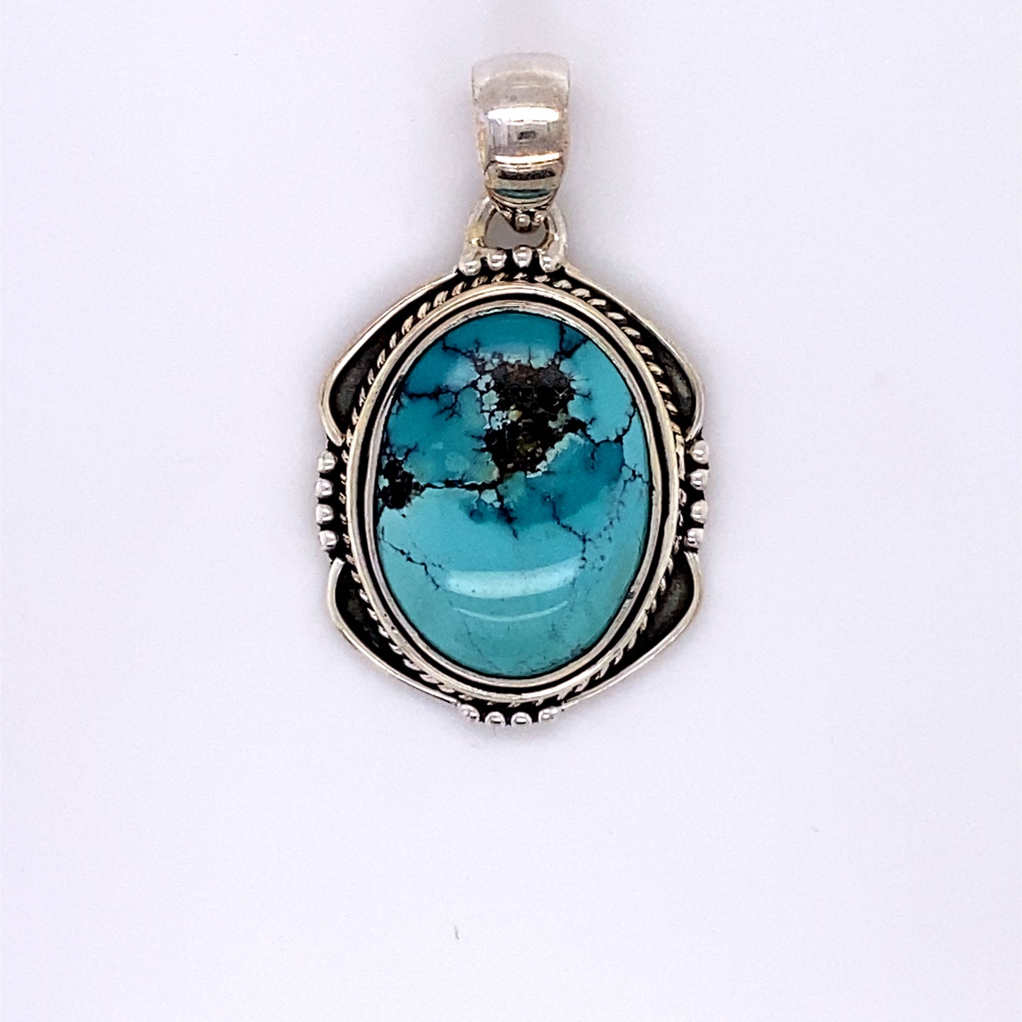 
                  
                    A Super Silver handmade sterling silver pendant with a Natural Turquoise Pendant with an Oval Shield Setting stone.
                  
                