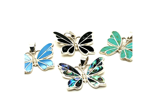
                  
                    Four Medium Inlay Butterfly Pendants in various colors, including blue, black, turquoise, and a multi-colored design, artfully crafted in sterling silver and gemstone jewelry, displayed against a white background.
                  
                