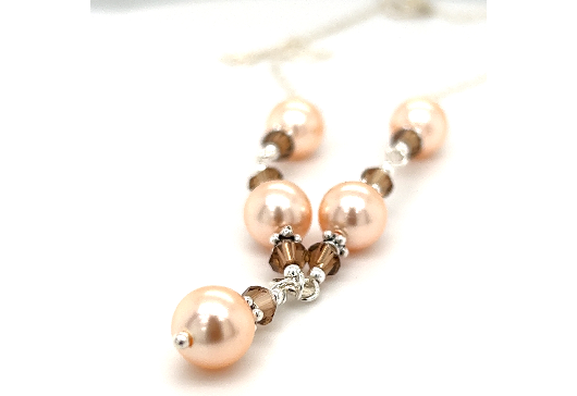 
                  
                    Peach Shell Pearl and Smokey Quartz necklace adorned with champagne shell pearls and Swarovski crystals, by Super Silver.
                  
                